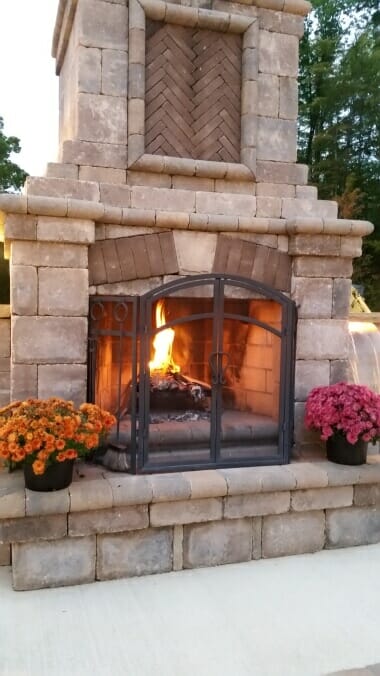 outdoor fireplace with a fire going